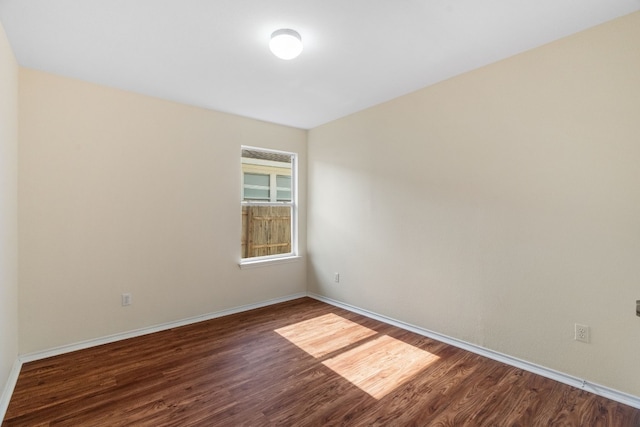 spare room featuring dark wood-type flooring