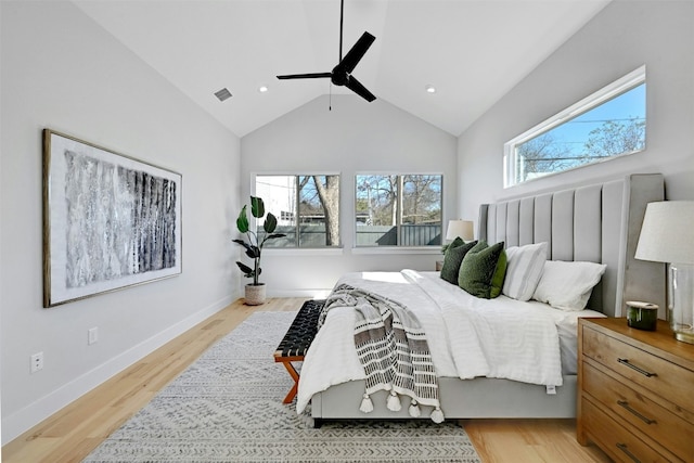 bedroom with ceiling fan, light hardwood / wood-style floors, and lofted ceiling