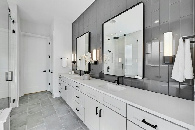 bathroom featuring vanity, an enclosed shower, and tile walls