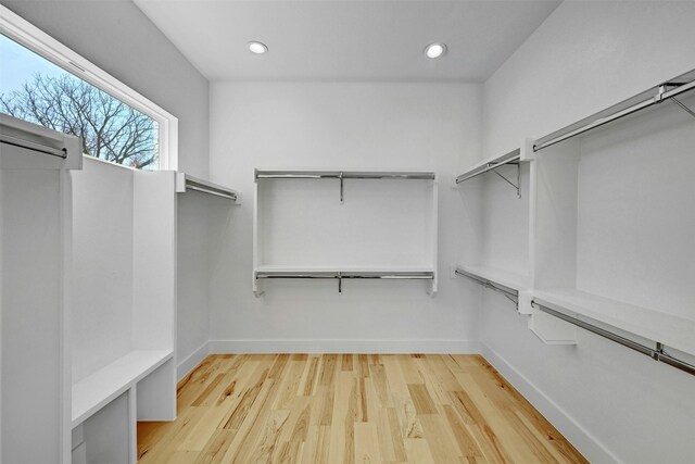 spacious closet featuring light hardwood / wood-style floors