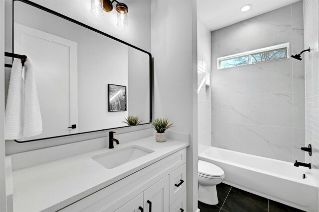 full bathroom with tile patterned floors, vanity, toilet, and tiled shower / bath combo