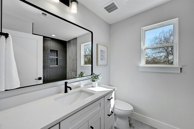 bathroom featuring vanity and toilet