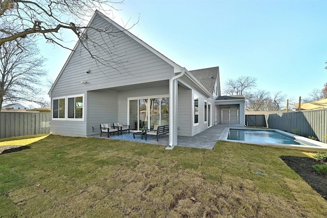 rear view of property with a lawn, an outdoor living space, a fenced in pool, and a patio