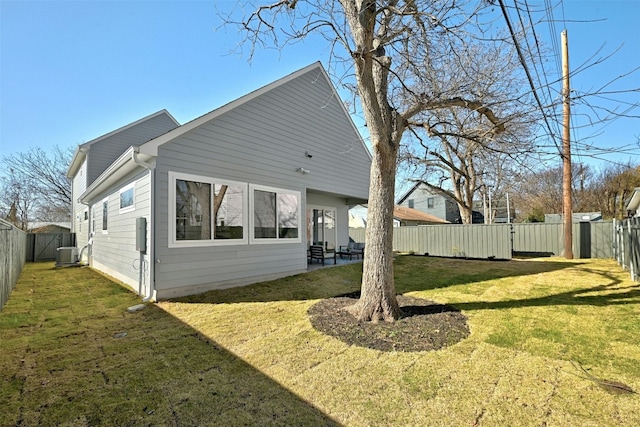 view of property exterior with central AC and a yard