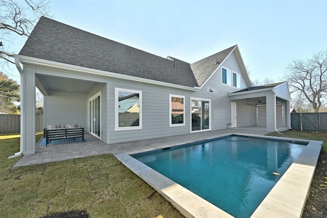 back of property featuring a fenced in pool, an outdoor living space, a yard, and a patio