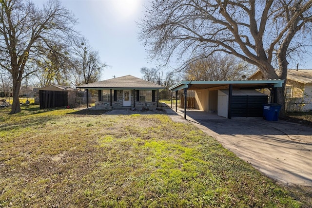 ranch-style house with covered porch, a front lawn, and a carport