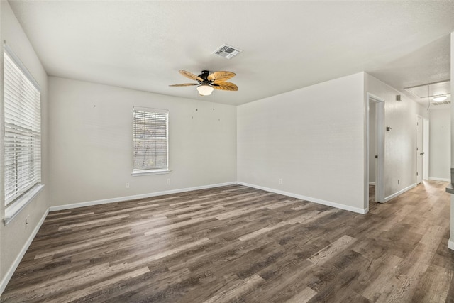 empty room featuring ceiling fan and dark hardwood / wood-style flooring