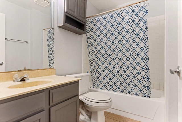 full bathroom featuring tile patterned floors, vanity, toilet, and shower / bath combo with shower curtain