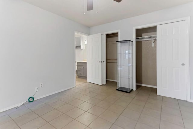 unfurnished bedroom featuring ceiling fan, a closet, and light tile patterned floors