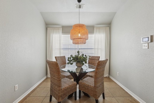 dining space featuring light tile patterned flooring