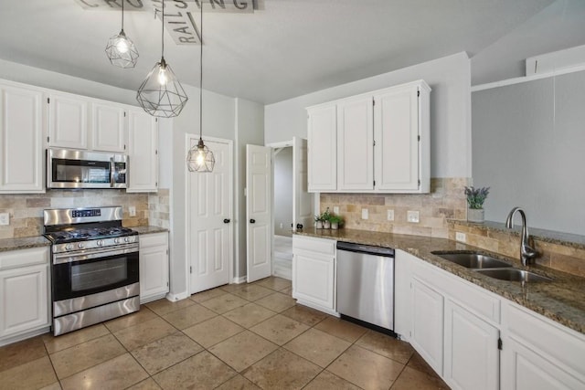 kitchen featuring white cabinetry, appliances with stainless steel finishes, and decorative light fixtures