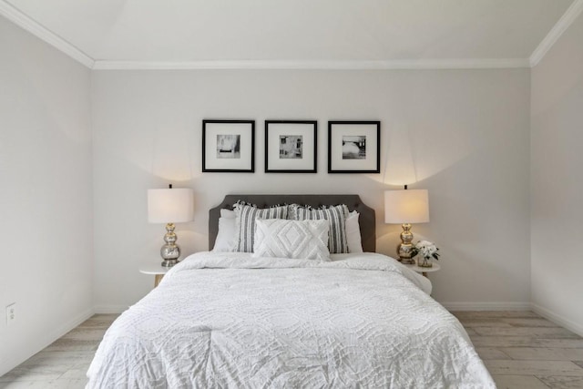 bedroom featuring ornamental molding and light wood-type flooring