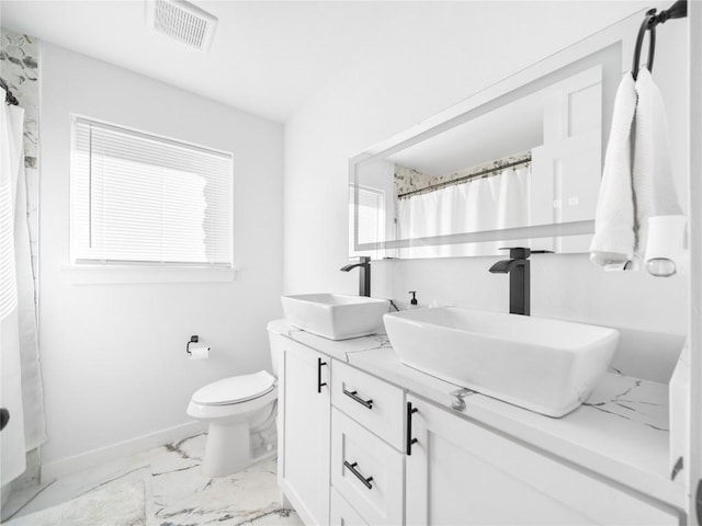 bathroom with walk in shower, vanity, and toilet