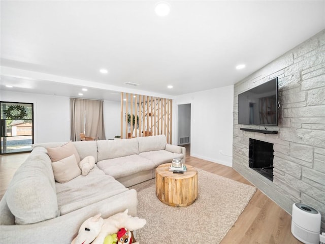 living room featuring a fireplace and light hardwood / wood-style floors