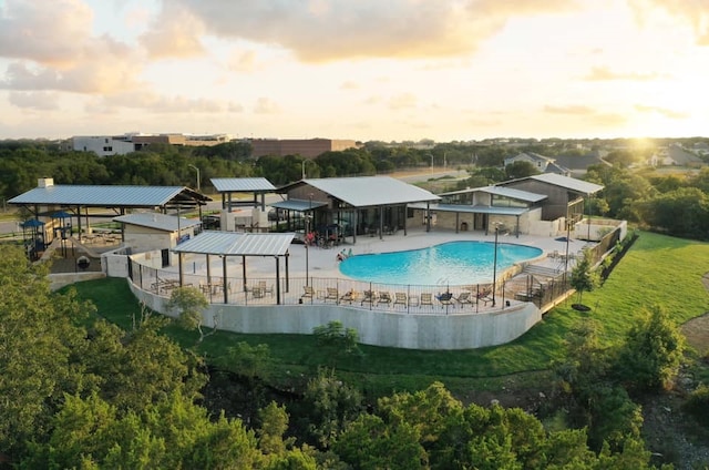 pool at dusk with a patio