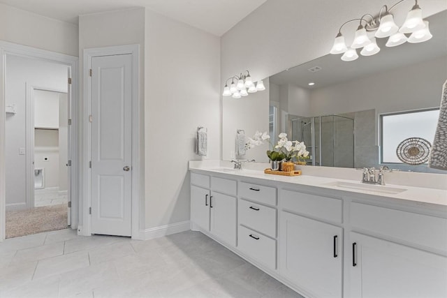 bathroom featuring vanity, an enclosed shower, and tile patterned floors