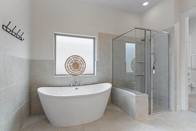 bathroom featuring shower with separate bathtub