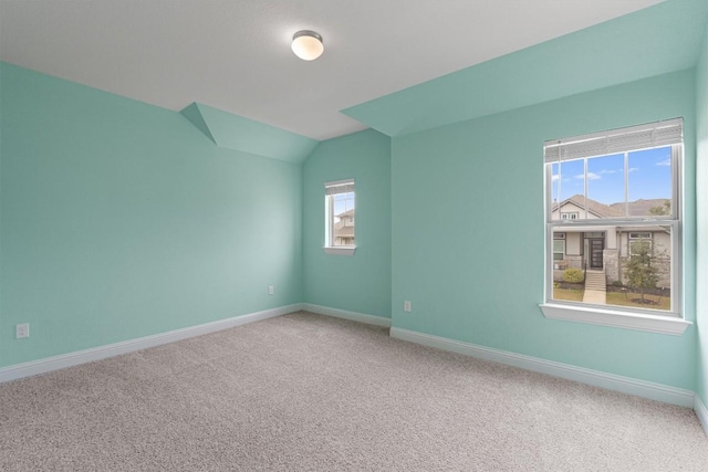 carpeted spare room with a wealth of natural light