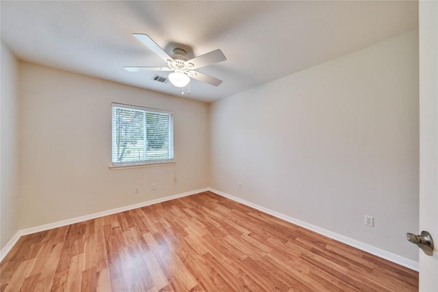 spare room featuring light wood-type flooring and ceiling fan