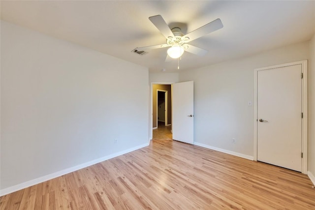 empty room featuring ceiling fan and light hardwood / wood-style floors