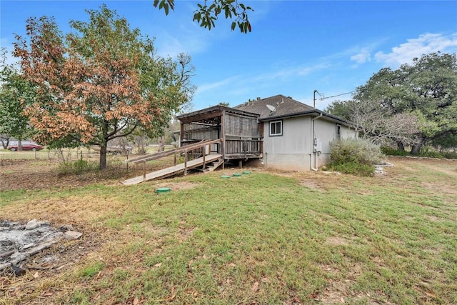 back of property featuring a deck and a yard