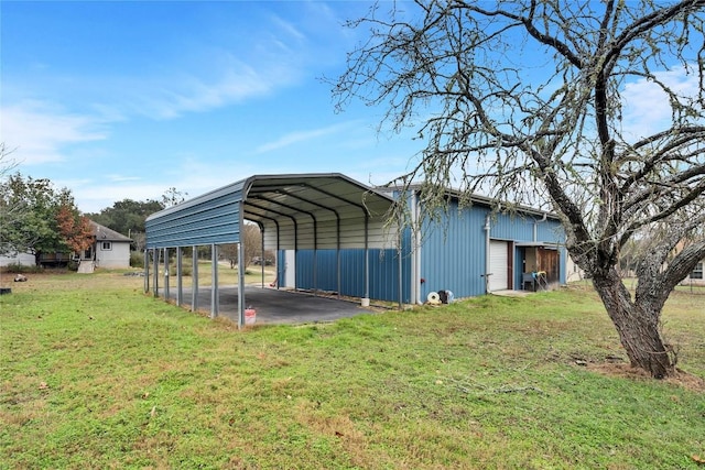 view of outbuilding featuring a yard, a garage, and a carport