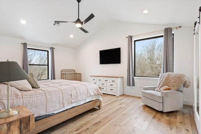 bedroom featuring ceiling fan, vaulted ceiling, and light hardwood / wood-style flooring