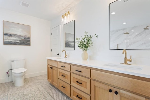 bathroom with tile patterned flooring, vanity, toilet, and walk in shower