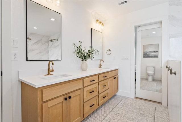 bathroom featuring tile patterned flooring, vanity, and toilet