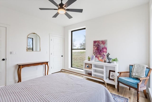 bedroom with ceiling fan and light hardwood / wood-style flooring