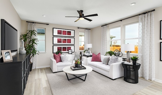 living room featuring light hardwood / wood-style flooring and ceiling fan