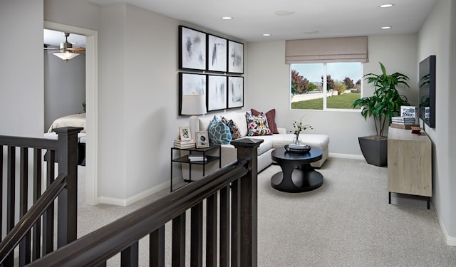 carpeted living room featuring ceiling fan