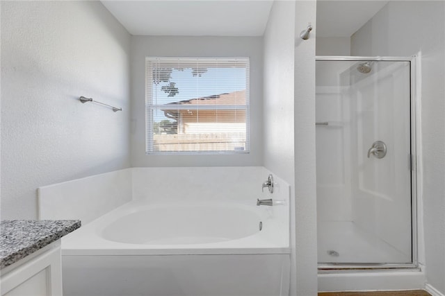 bathroom with vanity and separate shower and tub