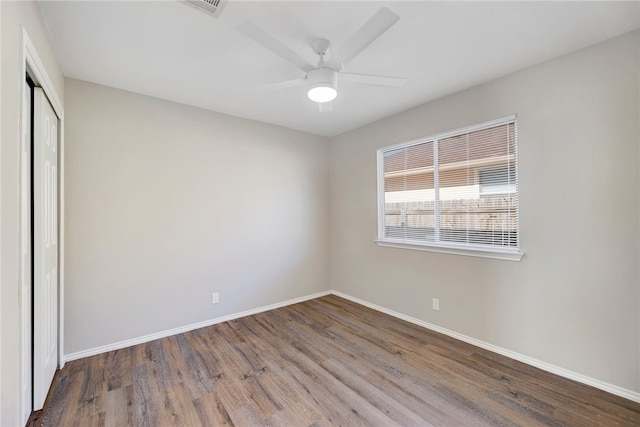 unfurnished bedroom featuring a closet, ceiling fan, and hardwood / wood-style floors