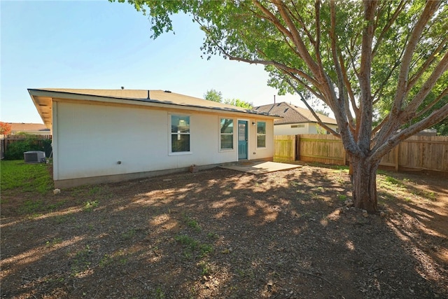 back of house featuring cooling unit