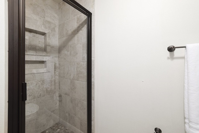 bathroom with a shower with shower door