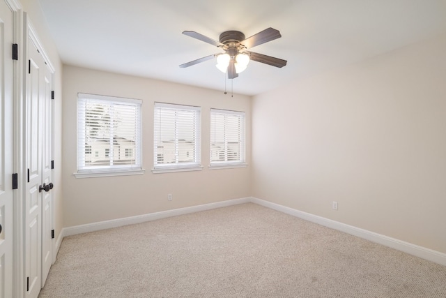 5801 Thunderbird St Unit A16, Lago Vista, TX 78645 - empty room featuring healthy amount of natural light, baseboards, light colored carpet, and ceiling fan