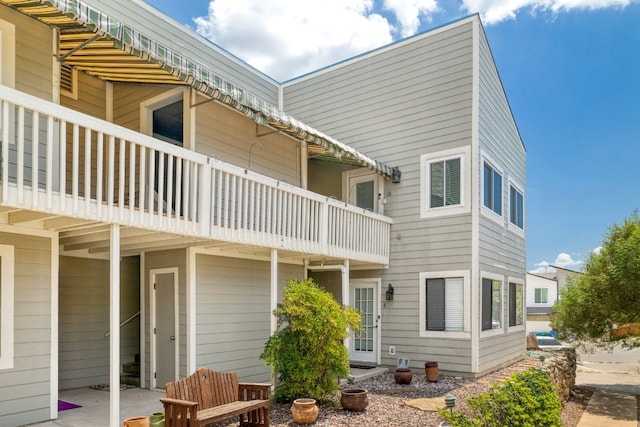 back of property featuring a balcony