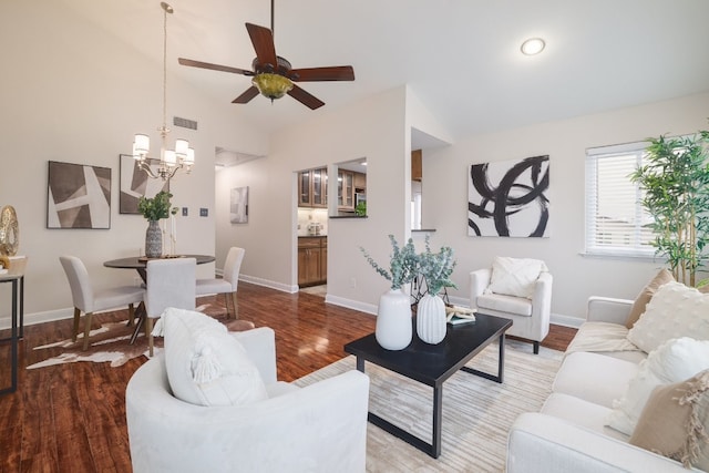 living room featuring ceiling fan with notable chandelier, light hardwood / wood-style flooring, and lofted ceiling