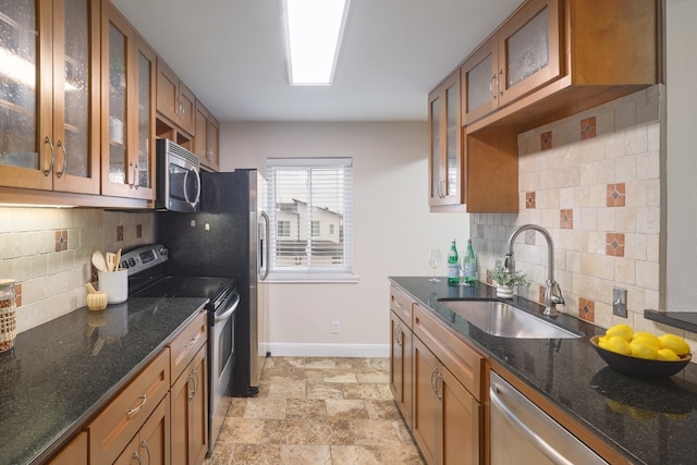 5801 Thunderbird St Unit A16, Lago Vista, TX 78645 - kitchen with appliances with stainless steel finishes, brown cabinetry, a sink, and decorative backsplash