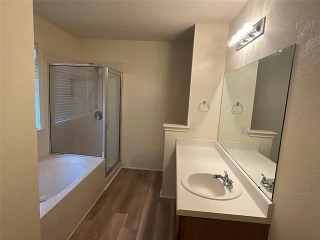 bathroom with vanity, wood-type flooring, and independent shower and bath