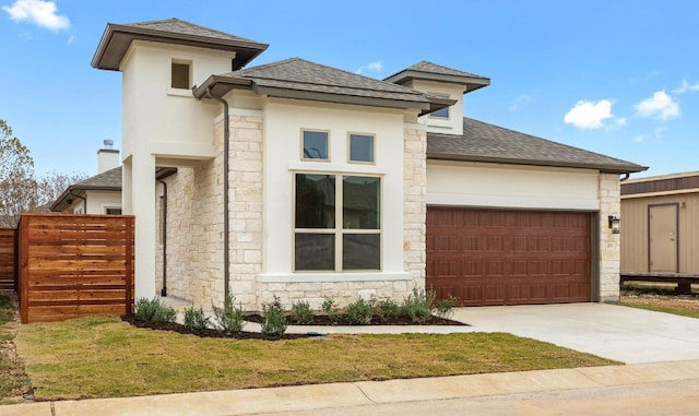 view of front of property featuring a garage and a front lawn