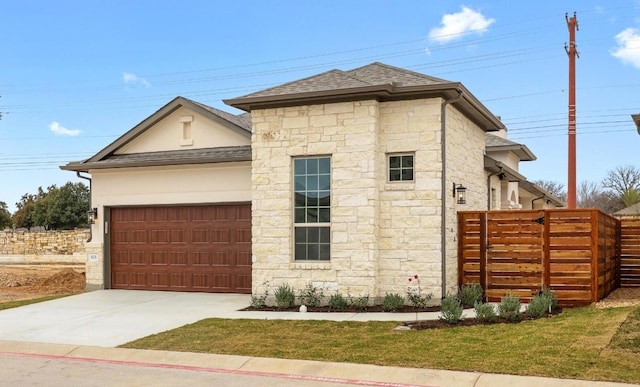 prairie-style home featuring a garage and a front yard