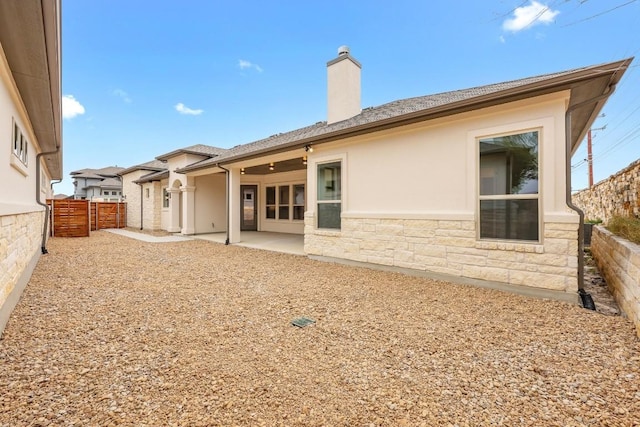 back of house with a patio