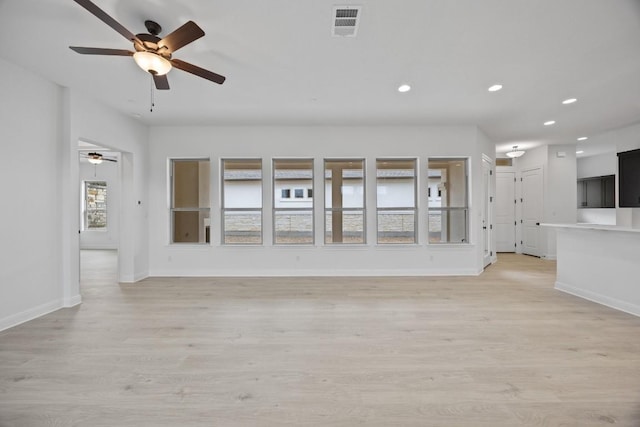 unfurnished living room with light wood-type flooring and ceiling fan