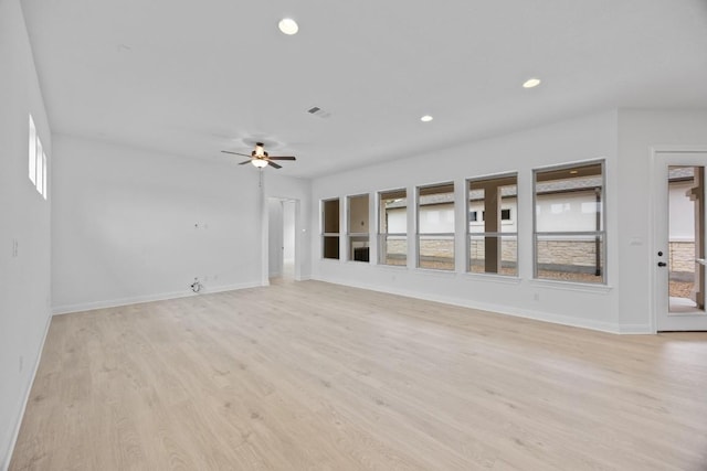 unfurnished living room with ceiling fan, a healthy amount of sunlight, and light hardwood / wood-style flooring