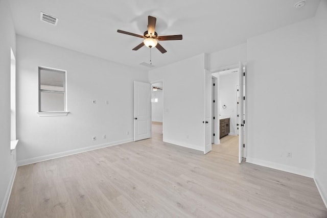 empty room with ceiling fan and light hardwood / wood-style flooring