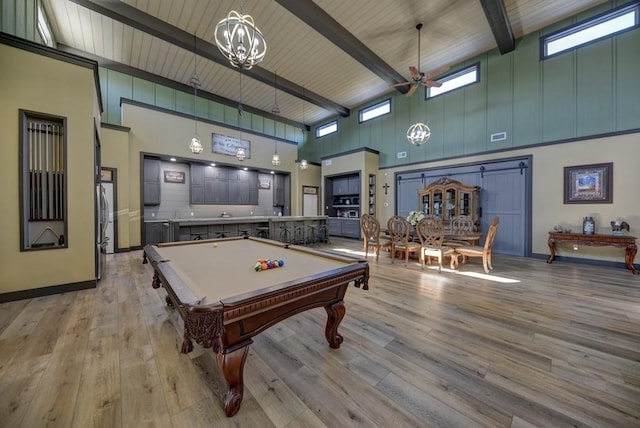 recreation room with a high ceiling, ceiling fan, light wood-type flooring, pool table, and beam ceiling