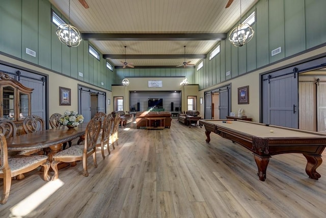 playroom with a barn door, ceiling fan, a towering ceiling, and beamed ceiling