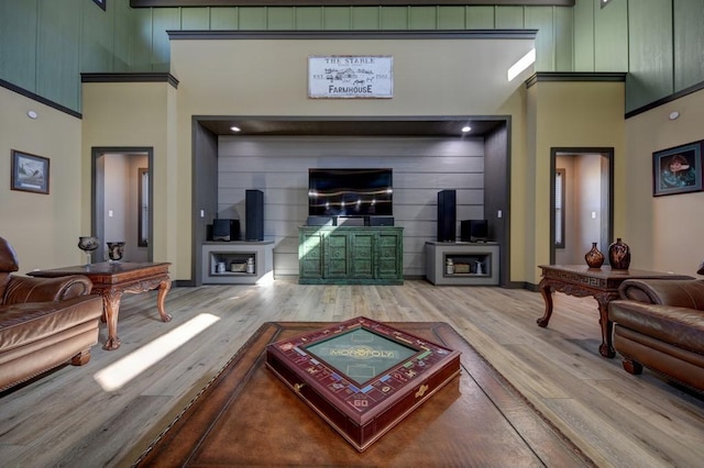 living room with hardwood / wood-style floors and a towering ceiling